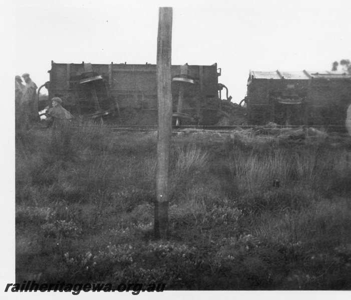 P02122
6 of 7 views of the derailment of No. 972 Goods near Westfield on the Jandakot to Armadale section of the FA line, a pair of wagons on their sides, view along the train showing the load of coal in the derailed wagons,  date of derailment 10/8/1955
