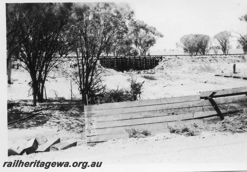 P02130
6 of 7 views of flooding and washaways on the Narrogin to Wagin section of the GSR, section of washed away track supported on a large 