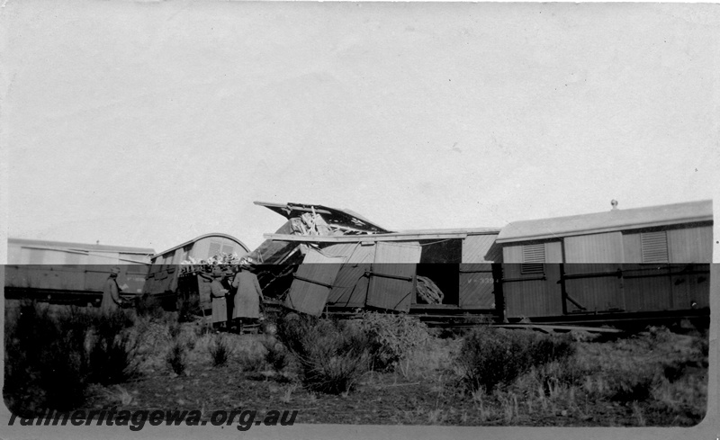 P02135
4 of 9 views of a derailment of No 26 Mixed on 26/6/1926 near Konnongorring, EM line, bogie vans including V class 3394 with diagonal planking, derailed
