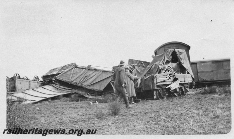 P02138
7 of 9 views of a derailment of No 26 Mixed on 26/6/1926 near Konnongorring, EM line, derailed and smashed wagons including D class 4153 with outside bracing and diagonal planking and H class 1916 with a motor vehicle on board
