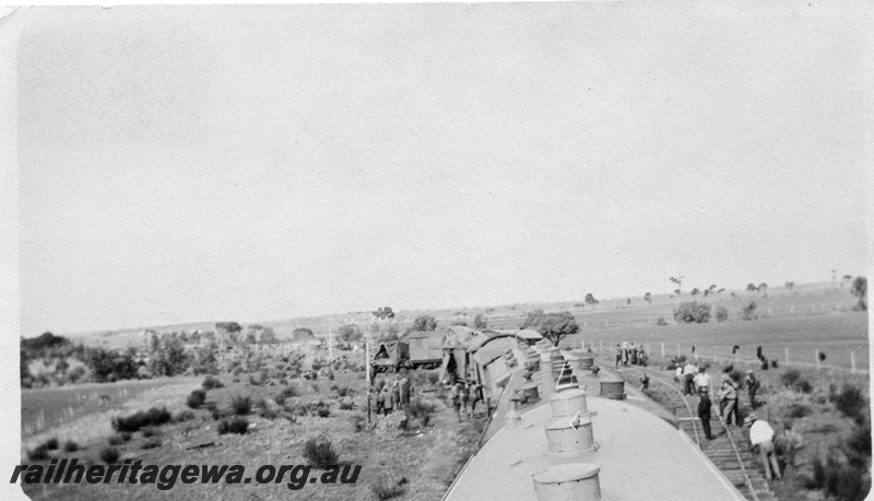 P02140
9 of 9 views of a derailment of No 26 Mixed on 26/6/1926 near Konnongorring, EM line, overall view of the site taken from the roof of a vehicle with oil lamps
