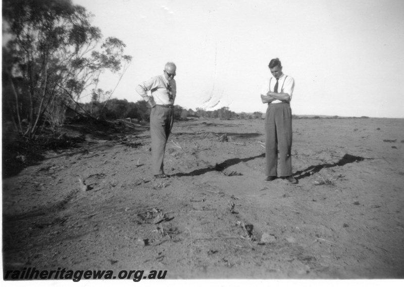 P02158
2 of 3 images of the construction of the water catchment at Kondinin, NKM line, two officials inspecting the 