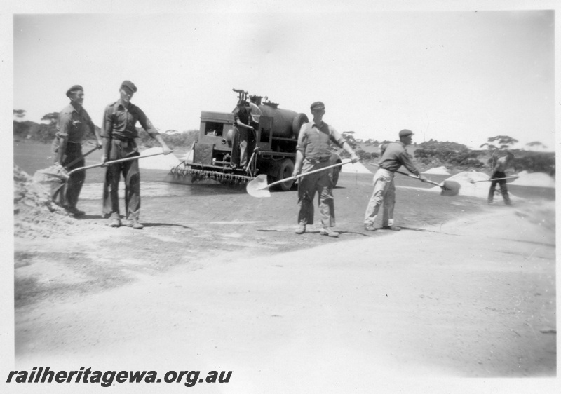 P02169
4 of 5 images of the construction of the dam at Duggan, WLG line showing the laying of bitumen on the catchment area and the covering of the area with sand
