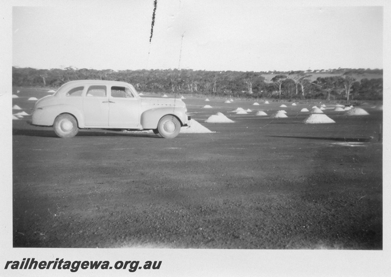 P02170
5 of 5 images of the construction of the dam at Duggan, WLG line showing the laying of bitumen on the catchment area and the covering of the area with sand
