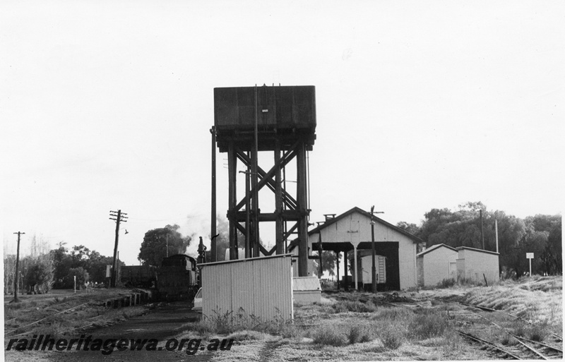 P02358
W class, water tower with a 25,000 gallon cast iron tank, engine shed, loco depot, Busselton, BB line, overall view of the depot.

