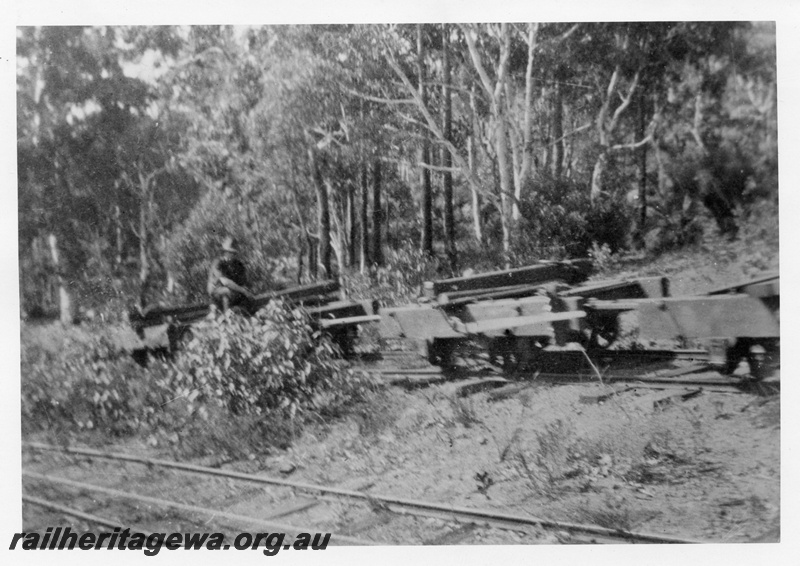 P02409
2 of 2. Descending trams on incline on Whittakers timber line. Showing workman riding on empty wagon. c1927.
