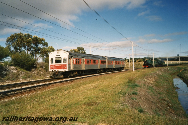 P02422
ADL class diesel railcar set and Hotham Valley steam train meet just north of the Tonkin Highway flyover.
