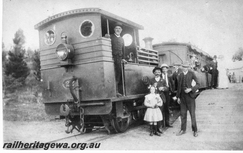 P02464
PWD loco H class 22, Mundaring Weir. MW line, end and side view, family group posing next to the loco.
