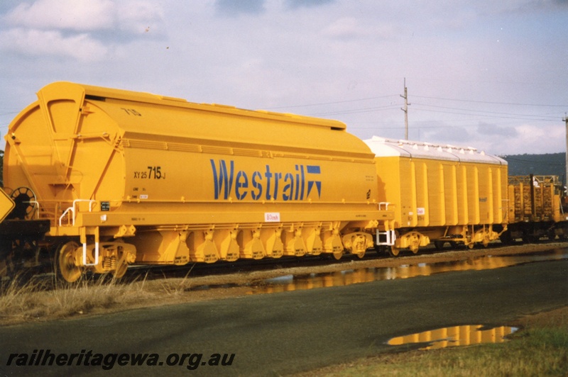P02545
XY class 25 715J mineral sands/coal hopper, RCH class RCH wooden bodied bulk grain wagon with fibreglass roof, new yellow livery, end and side view, Midland Workshop.


