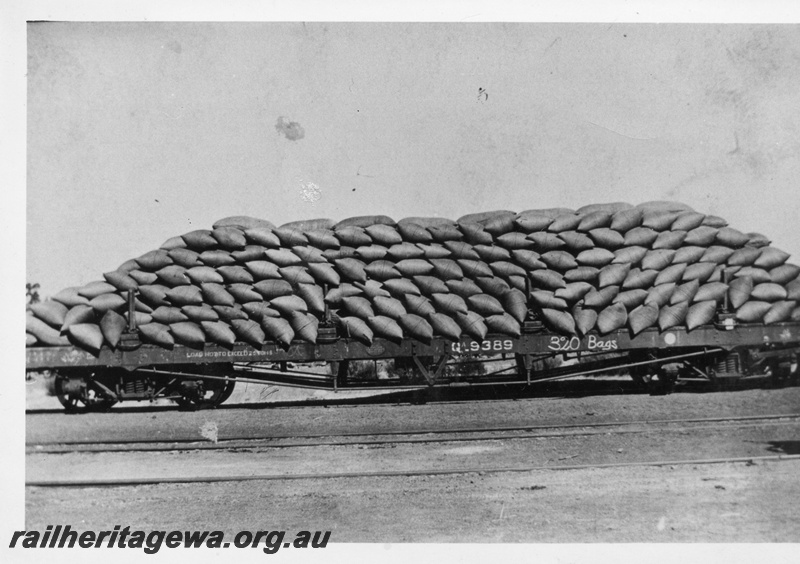 P02651
QA class 9389 flat wagon loaded with 320 bags of wheat, side view.
