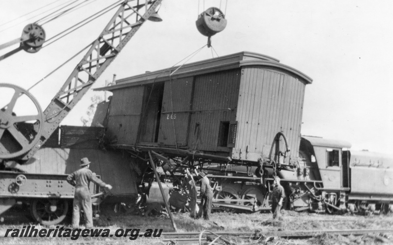 P02698
2 of 8. Brake down crane No. 23 lifting Z class 65 brakevan (with clerestory roof) off W class 957, Yarloop, side view, SWR line.
