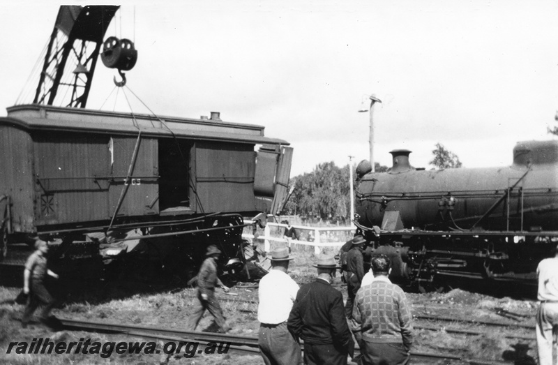 P02705
8 of 8. Brake down crane 23 lifting Z class 65 brakevan (with clerestory roof) clear from W class 951, Yarloop, side view, SWR line.
