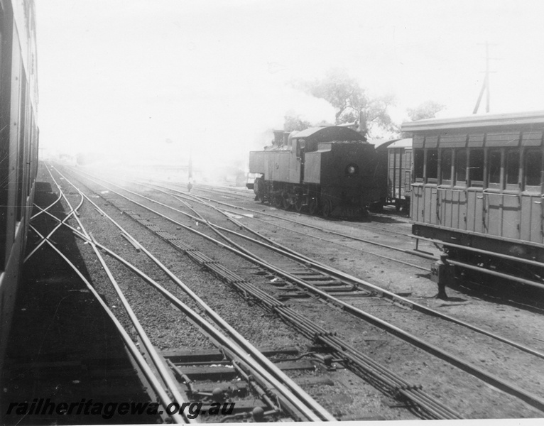 P02764
DM class 581, suburban side loading carriage, trackwork, point rodding, Midland Junction, view from an adjacent train looking across the yard.
