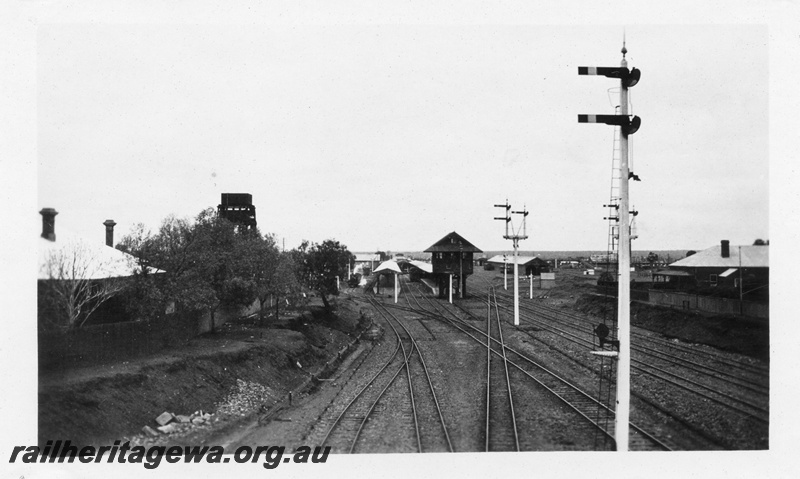 P02805
Signals, signal box, station buildings, 50,000 gallon water tower, Kalgoorlie, view looking west from Maritana Street Bridge
