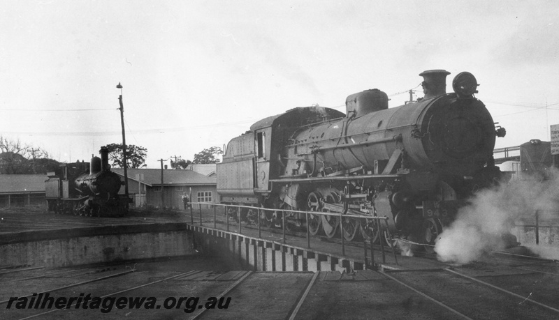 P02850
W class 943 steam locomotive on the turntable at Bunbury loco depot, side and front view, G class 123 steam locomotive in the background.
