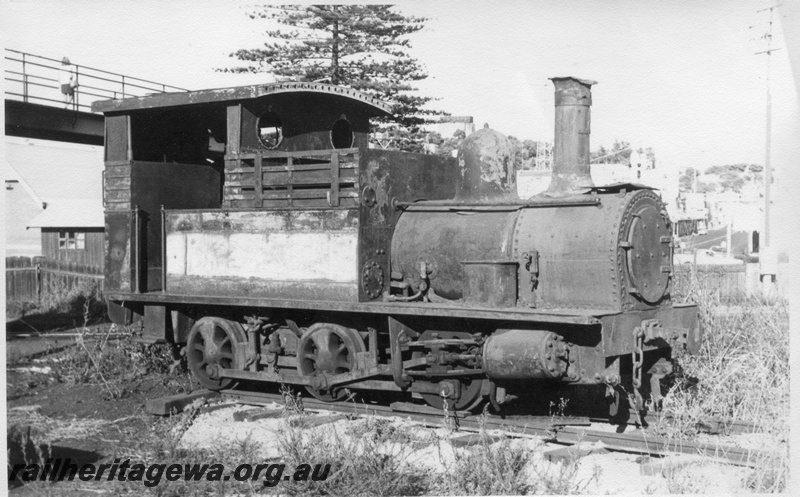 P02864
H class 18 steam locomotive side and front view, derelict, Bunbury, c1960s.
