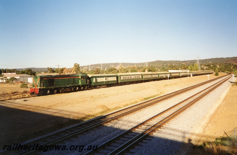 P02880
C class 1703 diesel locomotive, hauling a H.V.R. train, Z class 9 brakevan, front and side view, dual gauge tracks in the foreground, Bellevue, ER line.
