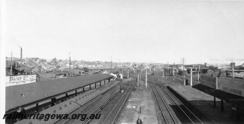 P02932
Perth station looking west, tracks, island platforms, station building end view, footbridge, passenger train at the passenger platform, signals, loco sheds, ER line, early 1900s.
