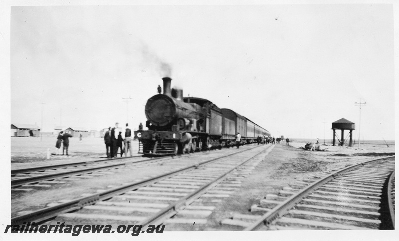 P02939
Commonwealth Railways (CR) G class 1 steam locomotive on passenger train working, opposite triangle and water tower, Trans train.
