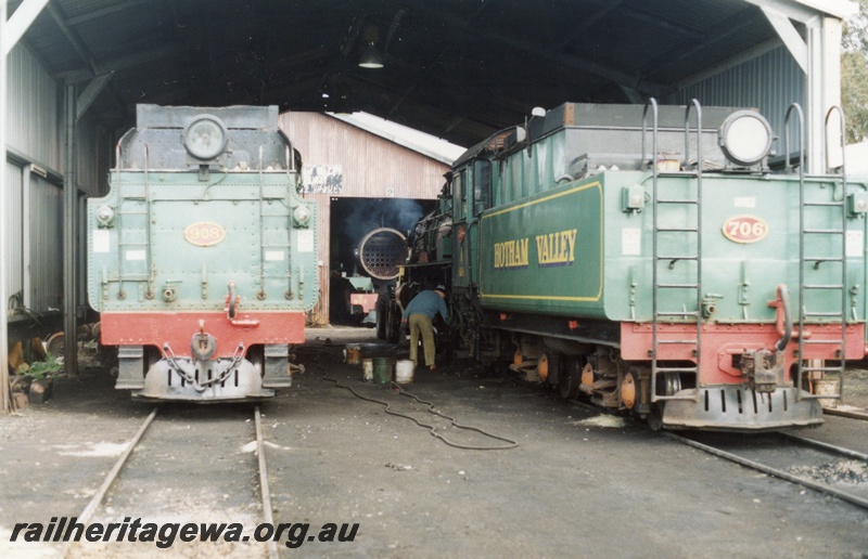 P02959
W class 908 and PM class 706 steam locomotives in the HVR loco shed, view of their tenders, view of W class 903's boiler tubes in the background, Pinjarra.
