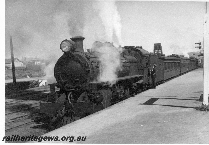 P03002
P class 448 steam locomotive on passenger train at platform, double 25,000 gallon tank water tower in the background, Northam, ER line.
