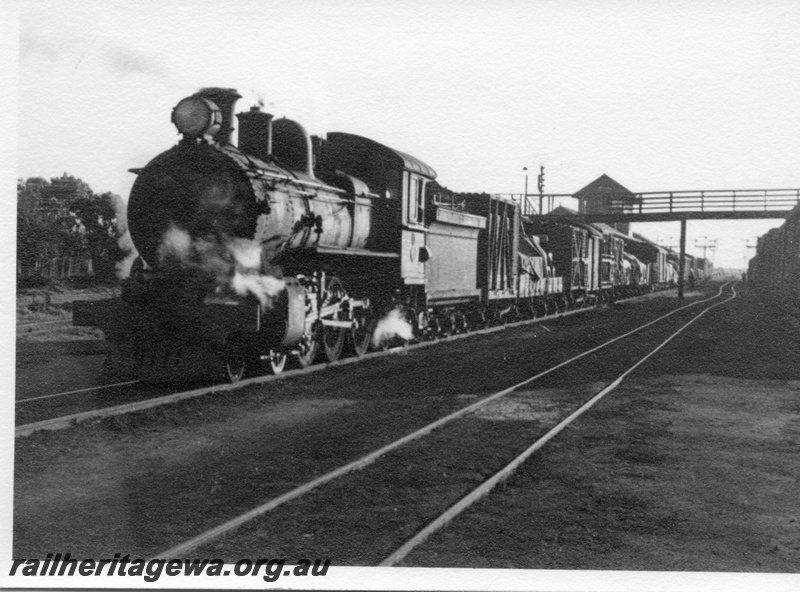 P03023
ES class 311 steam locomotive, on mixed train, front and side view, signal box and footbridge in the background, Merredin, EGR line.
