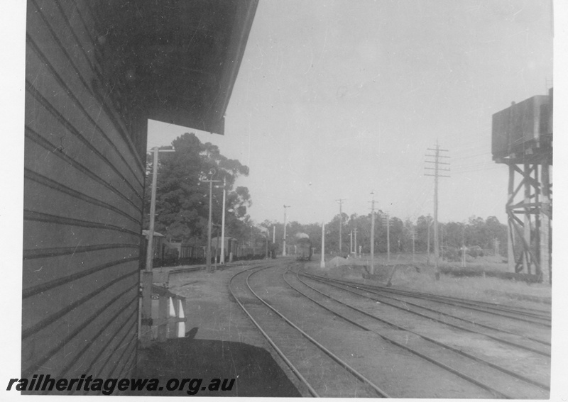 P03060
ES class 331 and ES class 350 steam locomotives, distant views, tracks, edge of water tower, edge of station building, Chidlow, ER line.
