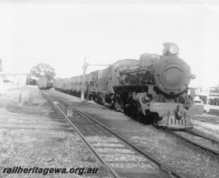 P03062
PMR class 730 steam locomotive, side and front view, taking on water at the water column, down goods train, station buildings, Cunderdin, EGR line. 
