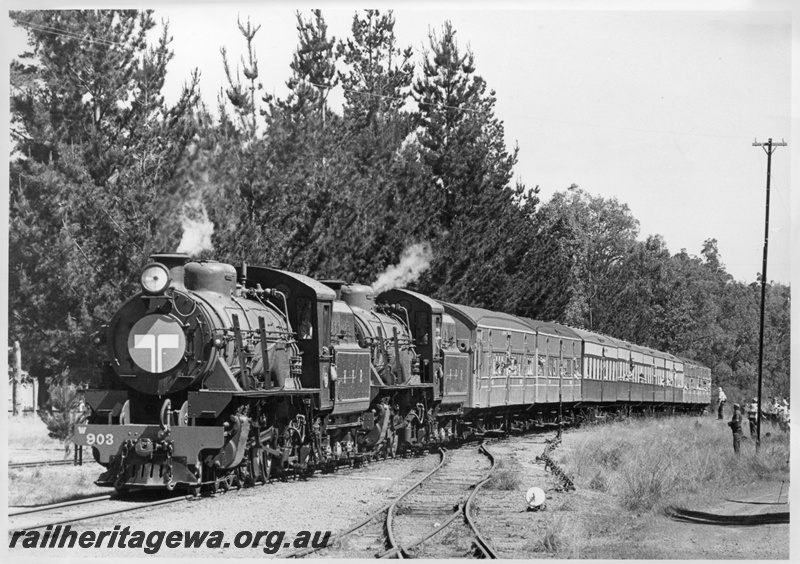 P03260
W class 903 double heading with W class 945 steam locomotives, lead loco a Telecom logo on the smoke box cover, arriving at Dwellingup on a HVR train, cheese knob, catch points, tall telegraph pole.
