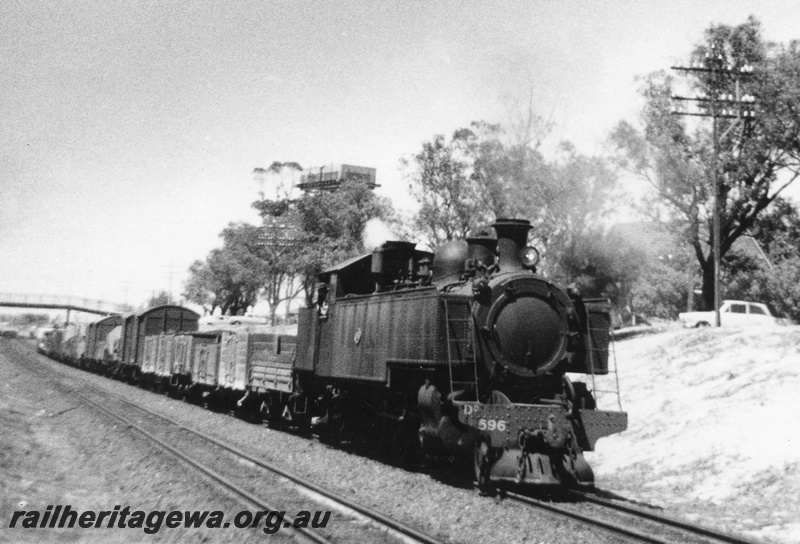 P03468
DD class 596 steam locomotive on a Down goods train, side and front view, water tower, footbridge, East Perth, ER line.
