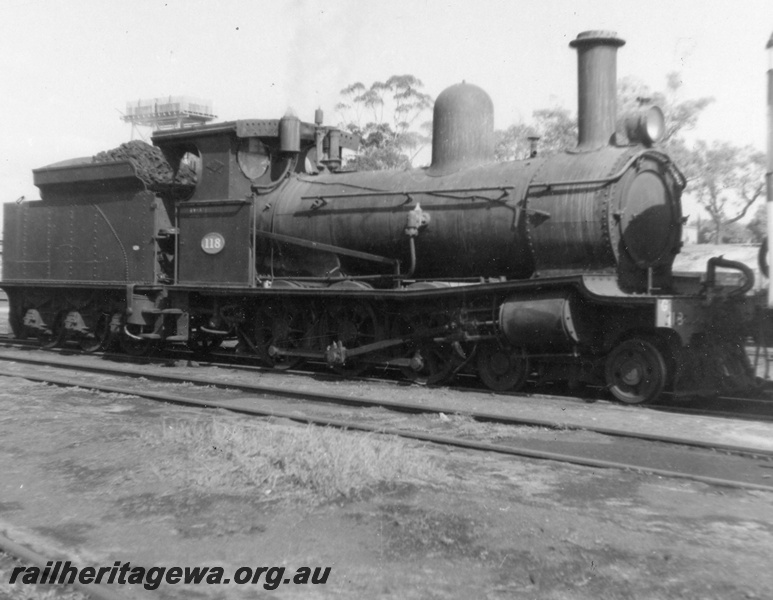 P03596
G class 118, 4-6-0. Yard shunting loco at East Perth Loco Sheds, Next to Unknown Rail Car. Side view
