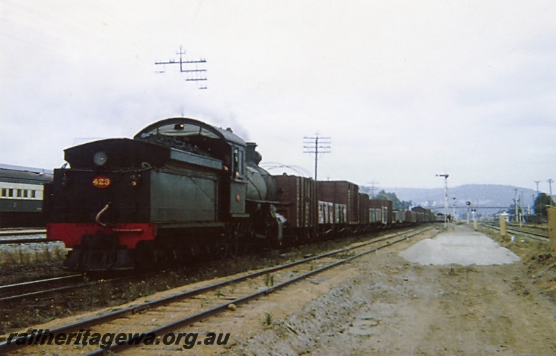 P03643
FS class 423 steam locomotive running tender first on a goods train, end and side view, signals, footbridge, relay boxes, ER line.
