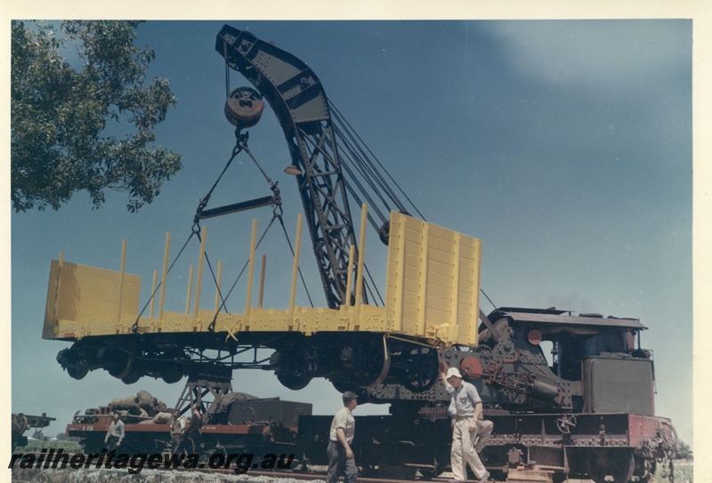 P03724
Cravens 25 ton breakdown crane No 23, lifting WSP flat top wagon, side view
