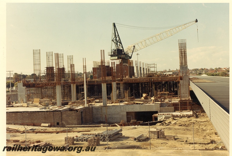 P03772
New terminal building at East Perth, view of construction site, crane and roof of temporary building.
