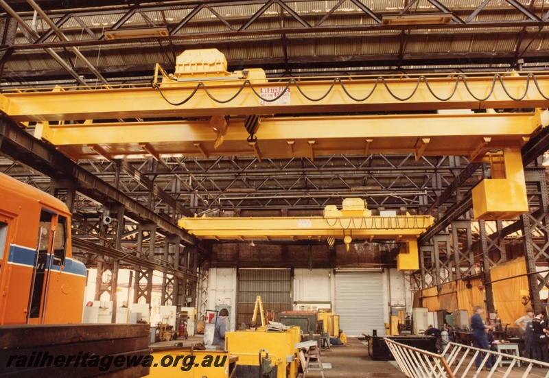 P03852
Fitting shop, block 3, Midland Workshops. Showing X class in Westrail orange with blue chevron and view of overhead cranes
