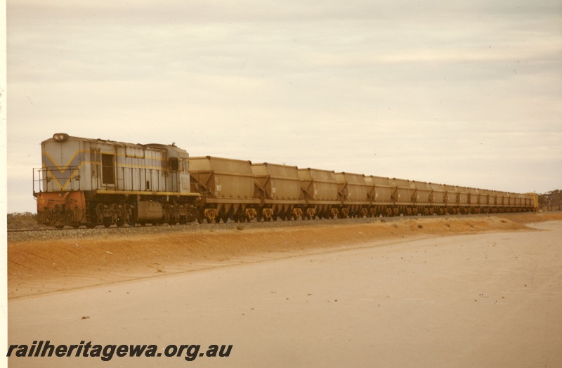 P03944
KA class 213 standard gauge diesel locomotive, hauling salt train, dark blue livery, front and side view, Lake Lefroy.
