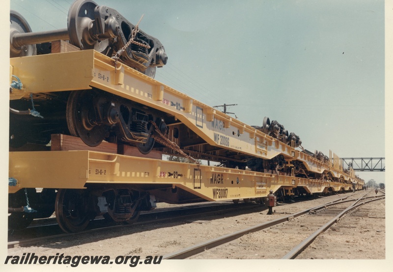 P03973
WF class 30087 flat top wagon with WF class 30086 flat top wagon, (later reclassified to WFDY), loaded piggy back, in as new condition, yellow livery.
