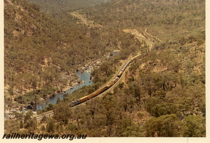 P03997
L class standard gauge diesel locomotive in dark blue livery, on freight train, elevated view, Avon Valley.
