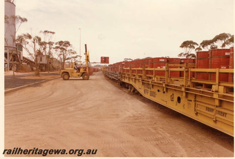 P04002
WFP class 30105 wagon, other WFP class wagons, (later reclassified to WFDY), drums being loaded by forklift, Hampton nickel refinery, view from fork lift side
