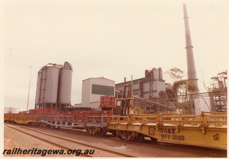 P04003
WFP class 30105 wagon, other WFP class wagons, (later reclassified to WFDY), drums being loaded by forklift, Hampton nickel refinery, view from opposite side to fork lift
