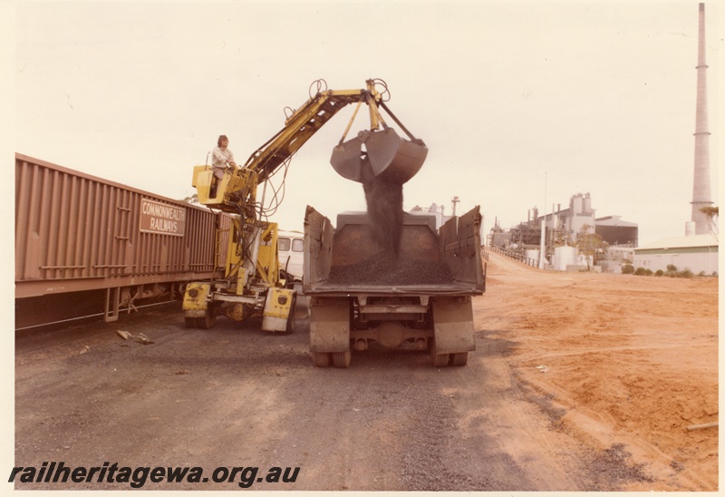 P04004
Commonwealth Railways (CR) wagon, being unloaded by excavator onto truck, Hampton nickel refinery, side view
