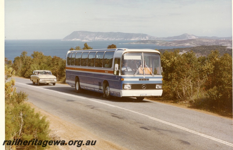 P04046
Mercedes Westrail bus, blue and white with yellow stripe, Albany area, Ford Falcon car following, side and front view
