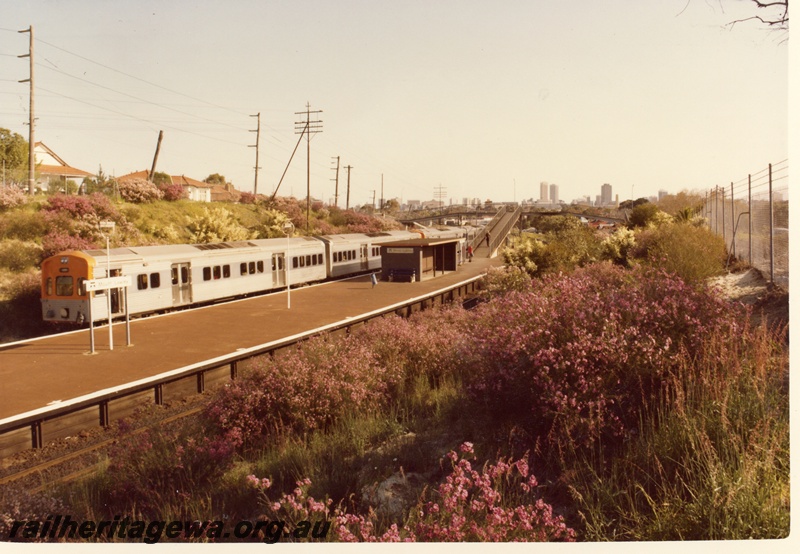 P04123
ADL  class railcar on four car set, station nameboard, station buildings, footbridge, Mount Lawley  end and side view, looking west towards the city 
