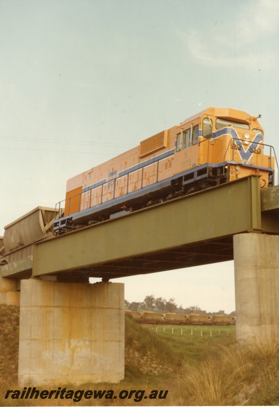 P04197
N class 1872, Westrail orange with blue and white stripe, on bauxite train, crossing steel and concrete bridge
