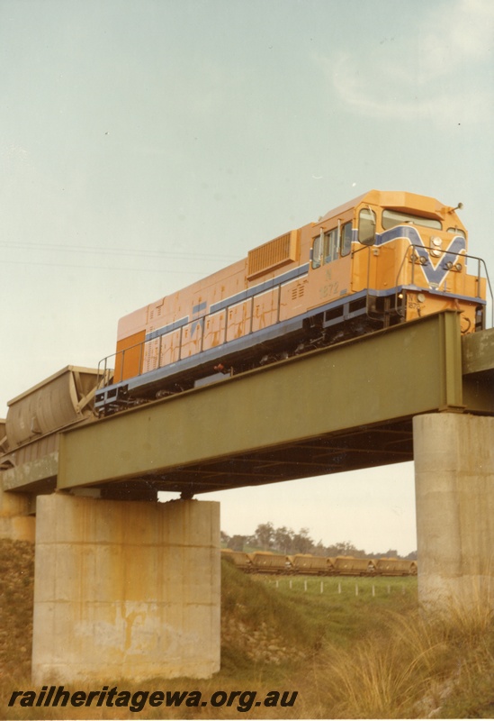 P04197
N class 1872, Westrail orange with blue and white stripe, on bauxite train, crossing steel and concrete bridge
