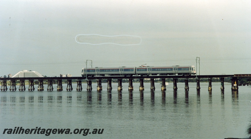 P04235
Two car suburban electric set, A series, crossing Bunbury Bridge, SWR line, Burswood Casino in background
