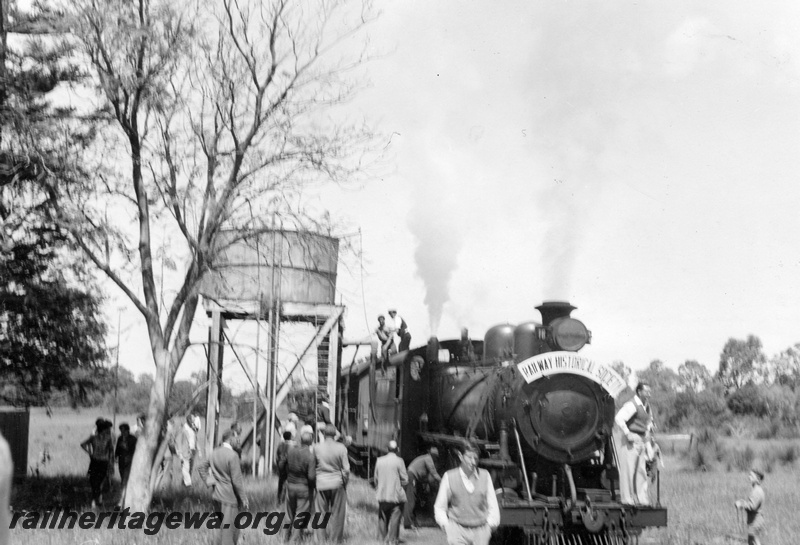 P04366
MRWA C class 18 steam locomotive, side and front view, taking on water, water tower, Muchea, MR line.
