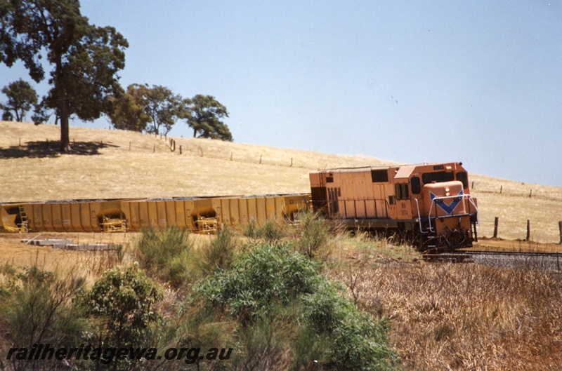 P04379
NA class 1874 diesel locomotive in Westrail orange livery on ballast train, side and front view, Brunswick Junction.
