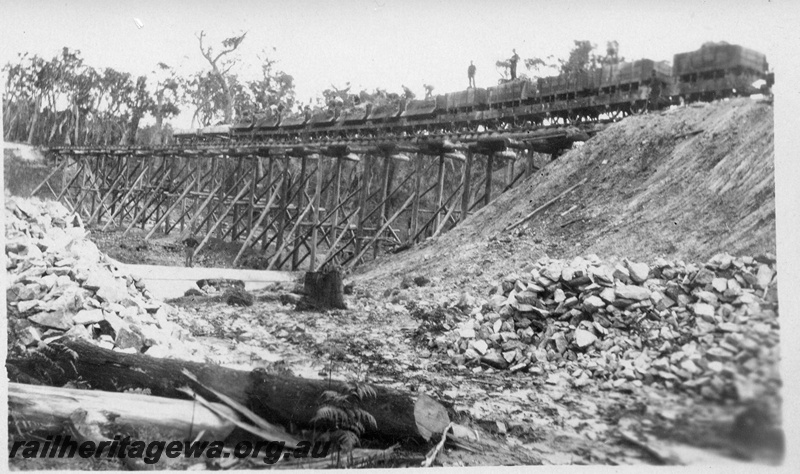 P04385
3 of 5, Trestles used for embankment construction, showing men shovelling fill material out of wagons over the side of the trestle, Denmark-Nornalup railway construction, c1928-29.
