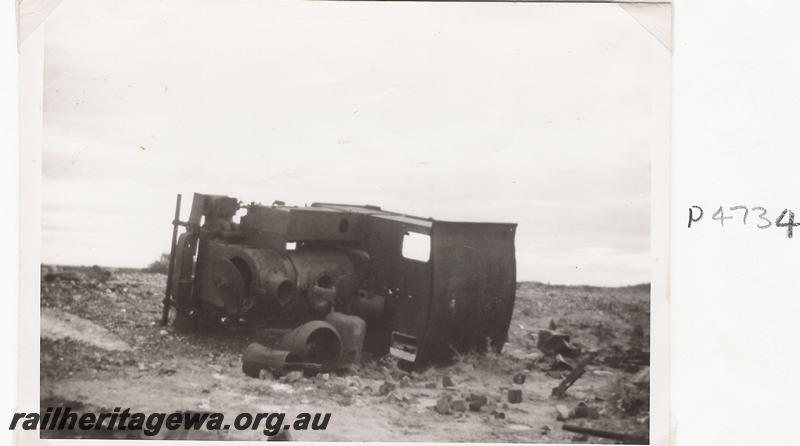 P04734
Haine St. Pierre loco, abandoned and laying on its side at Peak Hill, front and top view, same as P 07962,  c1965
